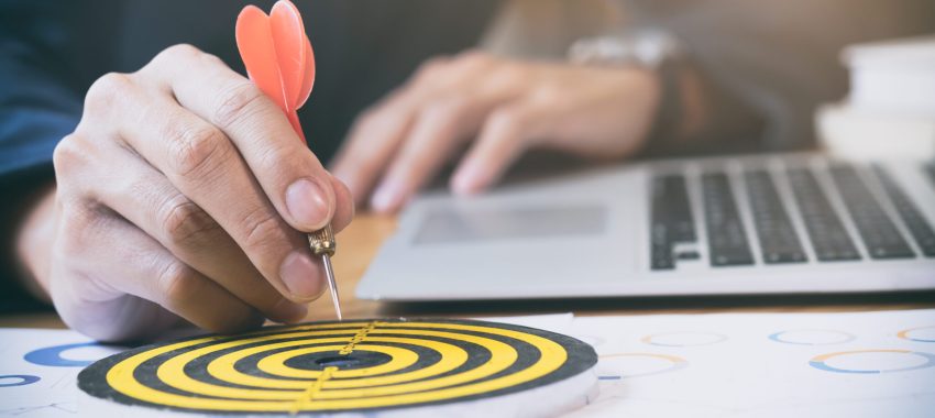 Businessman holding red dart push on target. Business strategy planning success target goals. Business development concept